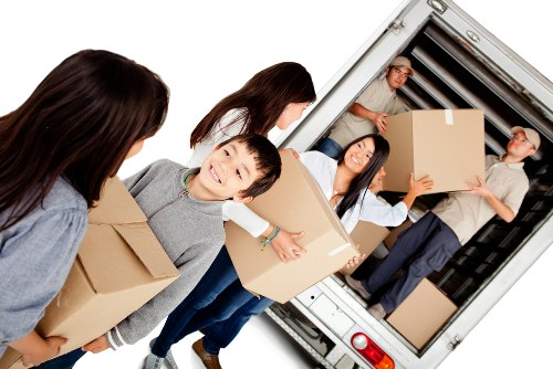 Professional movers navigating stairs in a period Earls Court property