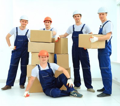 Helpers loading furniture for a small flat move in Earls Court