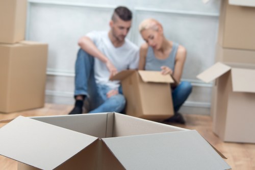 Movers handling desks and boxes during a commercial relocation