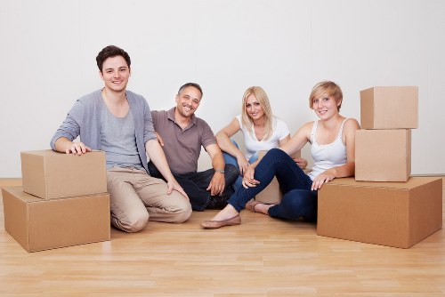 Professional movers carrying boxes through an apartment building