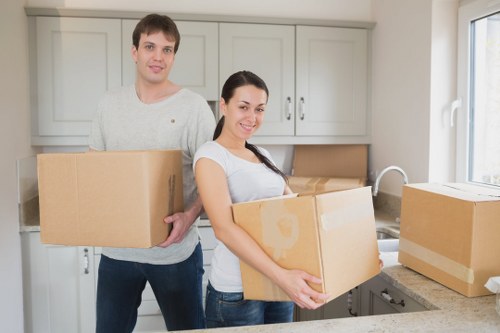 Movers handling furniture access in an Earls Court apartment building